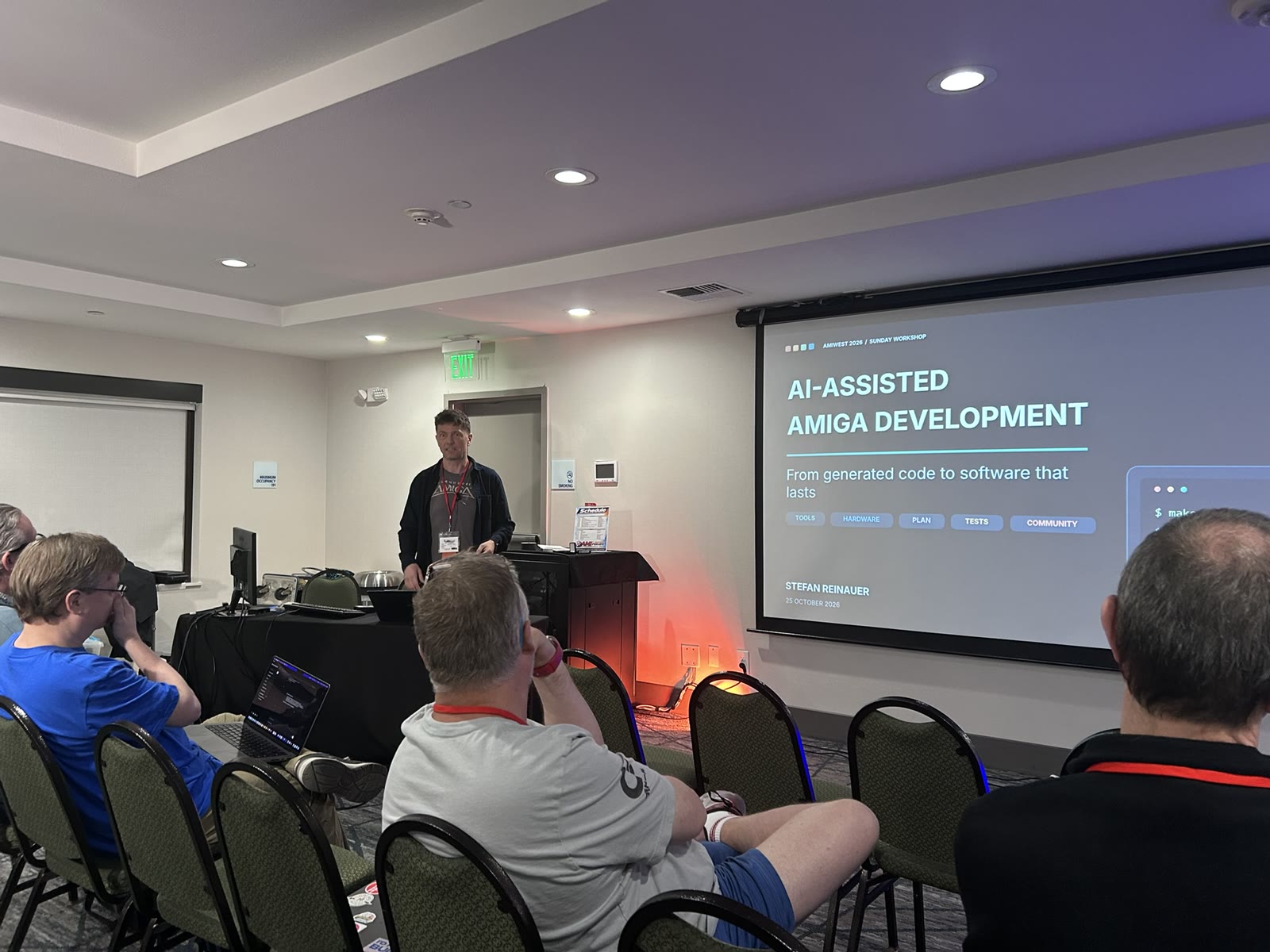 Workshop projection headed AI-Assisted Amiga Development, credited on the slide to Stefan Reinauer and dated 25 October 2026
