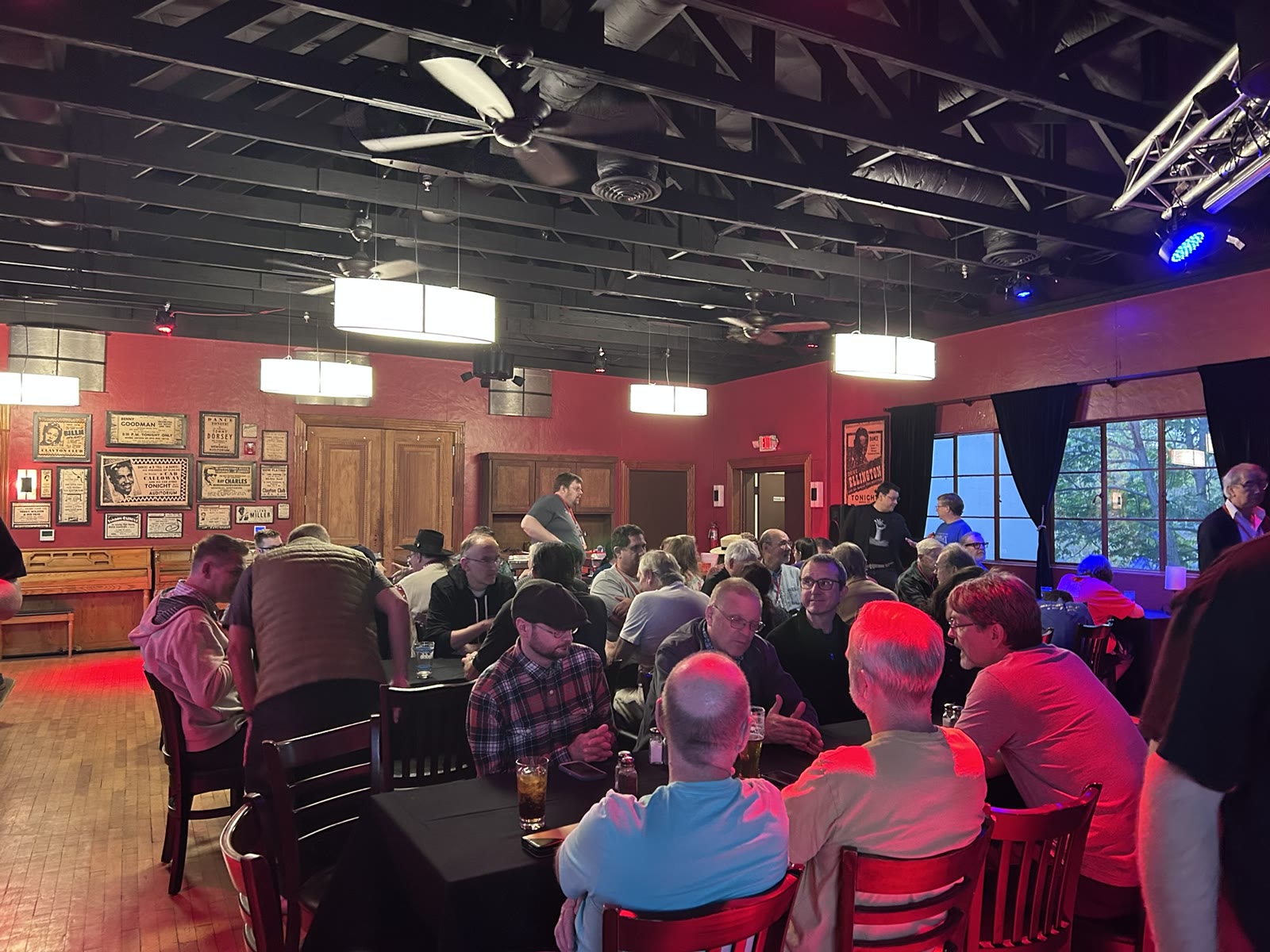 People gathered around tables during the AmiWest evening gathering